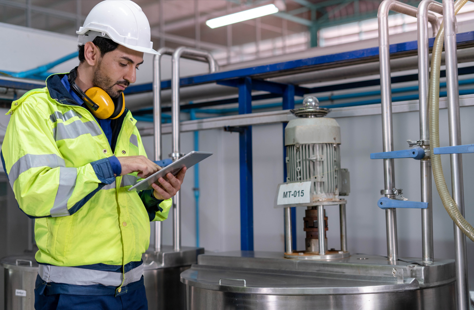 Water Hygiene Engineer inspecting commercial water treatment equipment during a routine maintenance visit